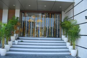 a building with stairs leading to the front door at The Ora Hotel in Vrindāvan