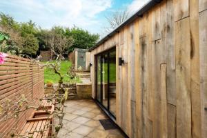 an internal view of a wooden house with a glass door at Cotswolds Cabin in Stonesfield