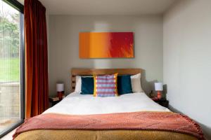 a bedroom with a bed and a window at Cotswolds Cabin in Stonesfield