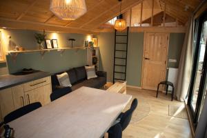 a living room with a table and a couch at Kapschuur in Zuidwolde +22 photos