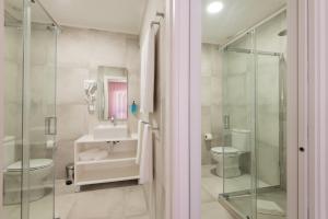 a bathroom with a sink and a toilet and a shower at LSA Campos by Numa in Lisbon +36 photos