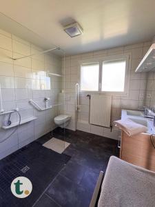 a bathroom with a sink and a toilet and a tub at Tranquiloue - Maison de Campagne - PuyduFou in Treize-Vents +25 photos