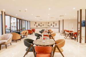a restaurant with tables and chairs and windows at Blend Elphistone Resort Marsa Alam in Abu Dabbab