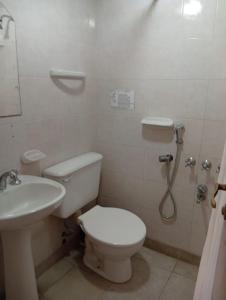 a bathroom with a toilet and a sink at PASEO GüEMES HOTEL in Salta +12 photos