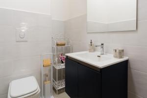 a bathroom with a sink and a toilet at Casa Stella Otranto Centre - Sea View, AC & WiFi in Otranto +13 photos