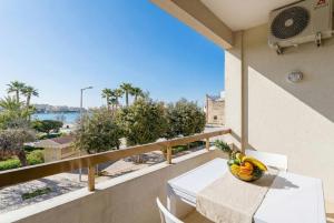 a balcony with a table and a bowl of fruit at Casa Stella Otranto Centre - Sea View, AC & WiFi in Otranto