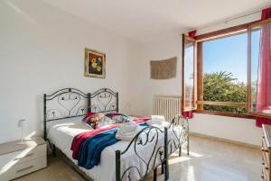 a bedroom with a bed and a window at Casa Stella Otranto Centre - Sea View, AC & WiFi in Otranto