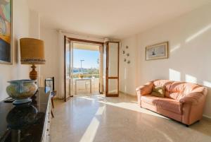 a living room with a leather couch and a window at Casa Stella Otranto Centre - Sea View, AC & WiFi in Otranto