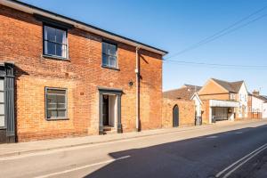 a brick building on the side of a street at The Leiston, Valley Road in Leiston