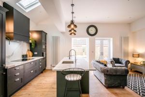 a kitchen with a couch and a table in a room at The Leiston, Valley Road in Leiston