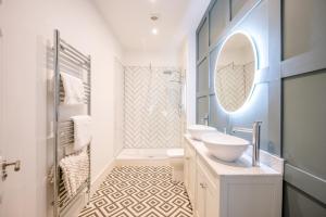 a white bathroom with two sinks and a mirror at The Leiston, Valley Road in Leiston +23 photos