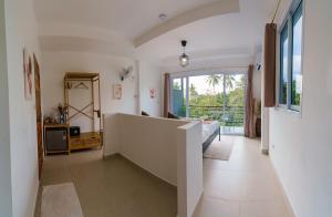 a room with a staircase with a bed and a window at Aura Koh Tao in Ko Tao
