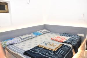 a bed with blankets and pillows on top of it at Hotel Maa Karni Darbar in Deshnoke