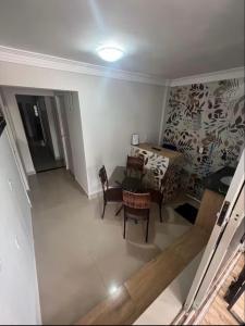 a view of a living room with a table and chairs at Pousada 705 norte 1 in Brasília