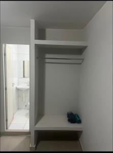 a white bathroom with a sink and a toilet at Pousada 705 norte 1 in Brasília