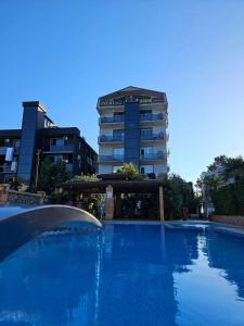 a large swimming pool in front of a building at IVERIABEACH in Kobuleti