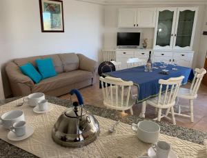 a kitchen and living room with a table and a couch at Valledoria holiday flats in Valledoria