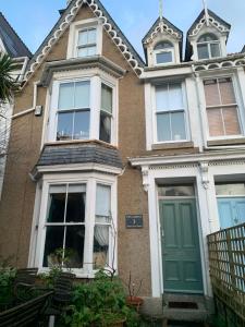 a house with a green door on a street at Chy Sabona - Front Room in Penzance
