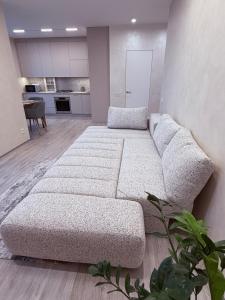 a large white couch in a living room at Центр стадіон Central Сity Замкова in Rivne +3 photos