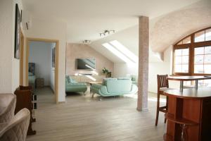 a living room with a couch and a table at Apartmány U Stadionu in Šumperk