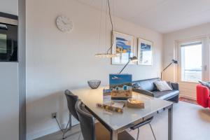 a living room with a table and a couch at Appartementencomplex Juliana 152 in De Koog