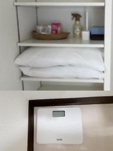 a white shelf with a bed in a room at 551 Namba in Osaka