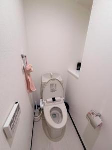 a white bathroom with a toilet in a room at 551 Namba in Osaka