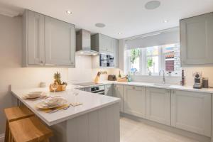 a kitchen with white cabinets and a large window at 3 Bed in Helmsley oc-y111 in Helmsley