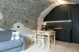 a living room with a table and a couch at Grotta Bàlzer in Valdidentro +95 photos