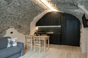 a living room with a couch and a table at Grotta Bàlzer in Valdidentro