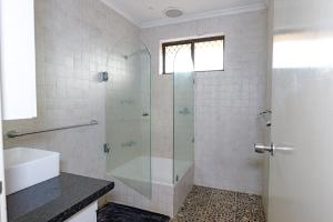a bathroom with a shower with a glass door at Pamusha 2 in Geraldton +9 photos