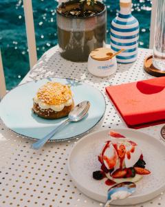 a table with plates of food on top of it at Les Roches Rouges, a Beaumier hotel in Saint-Raphaël