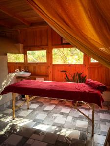 a room with a large red bench in a bathroom at Riad Golden Baibah in Zaouia Akermoud +65 photos