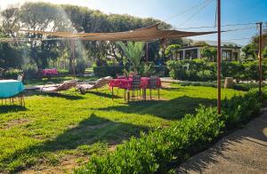 a table and chairs under a canopy in a yard at Riad Golden Baibah in Zaouia Akermoud