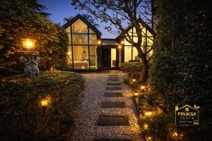 a pathway leading to a house at night with lights at Pruksa Place Udon Thani in Udon Thani