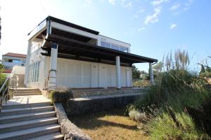 a house with a staircase leading up to it at Sea side Punat in Punat