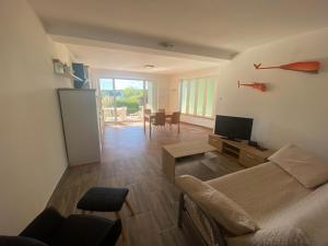a living room with a couch and a tv at Sea side Punat in Punat