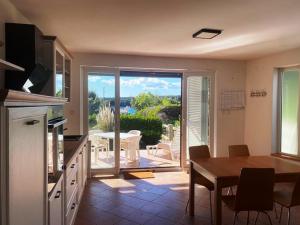 a kitchen with a table and a view of a patio at Sea side Punat in Punat