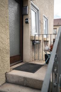 a door to a balcony with a table on the porch at KiRoom Willsbach 2 und 3 in Obersulm
