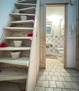 a bathroom with wooden shelves with flowers on them at La torretta del SUD in Bisceglie +8 photos