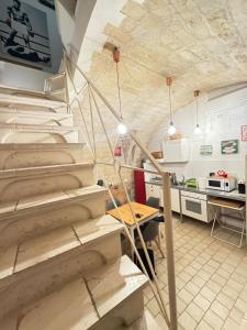 a room with stairs and a kitchen with a table at La torretta del SUD in Bisceglie