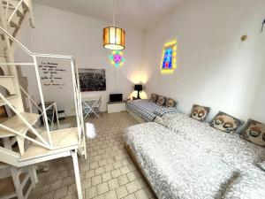 a bedroom with a bed and a staircase in it at La torretta del SUD in Bisceglie