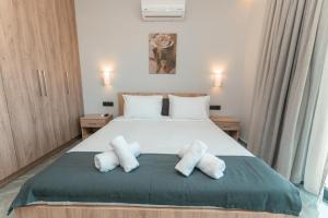 a bedroom with a bed with two pillows on it at Aurora 3 - Family Comfort near the beach in Marmari