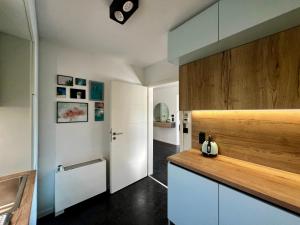 a kitchen with white cabinets and a wooden counter top at Traum Berg - Koppelberg 2 in Traben-Trarbach