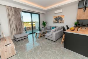 a living room with a couch and a table at Aurora 3 - Family Comfort near the beach in Marmari