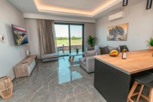 a living room with a kitchen and a living room with a table at Aurora 3 - Family Comfort near the beach in Marmari