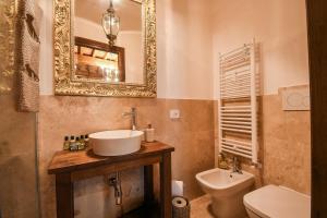 a bathroom with a sink and a toilet and a mirror at Prugnolo Grand View in Montepulciano +23 photos