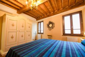 a bedroom with a large blue bed in a room at Prugnolo Grand View in Montepulciano