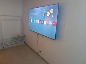 a projection screen on a wall in a room at Chambre aménagée dans un hôtel in Douala