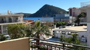 a view of the ocean from a balcony of a building at Hotel Pitsakis in Tolo